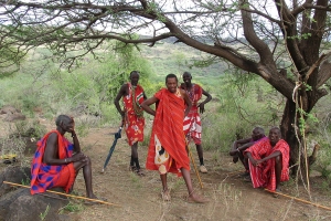 In rural areas, Maasai men, dress traditionally and periodically meet together to "eat meat" and discuss community problems, like predators attacking their cattle. 